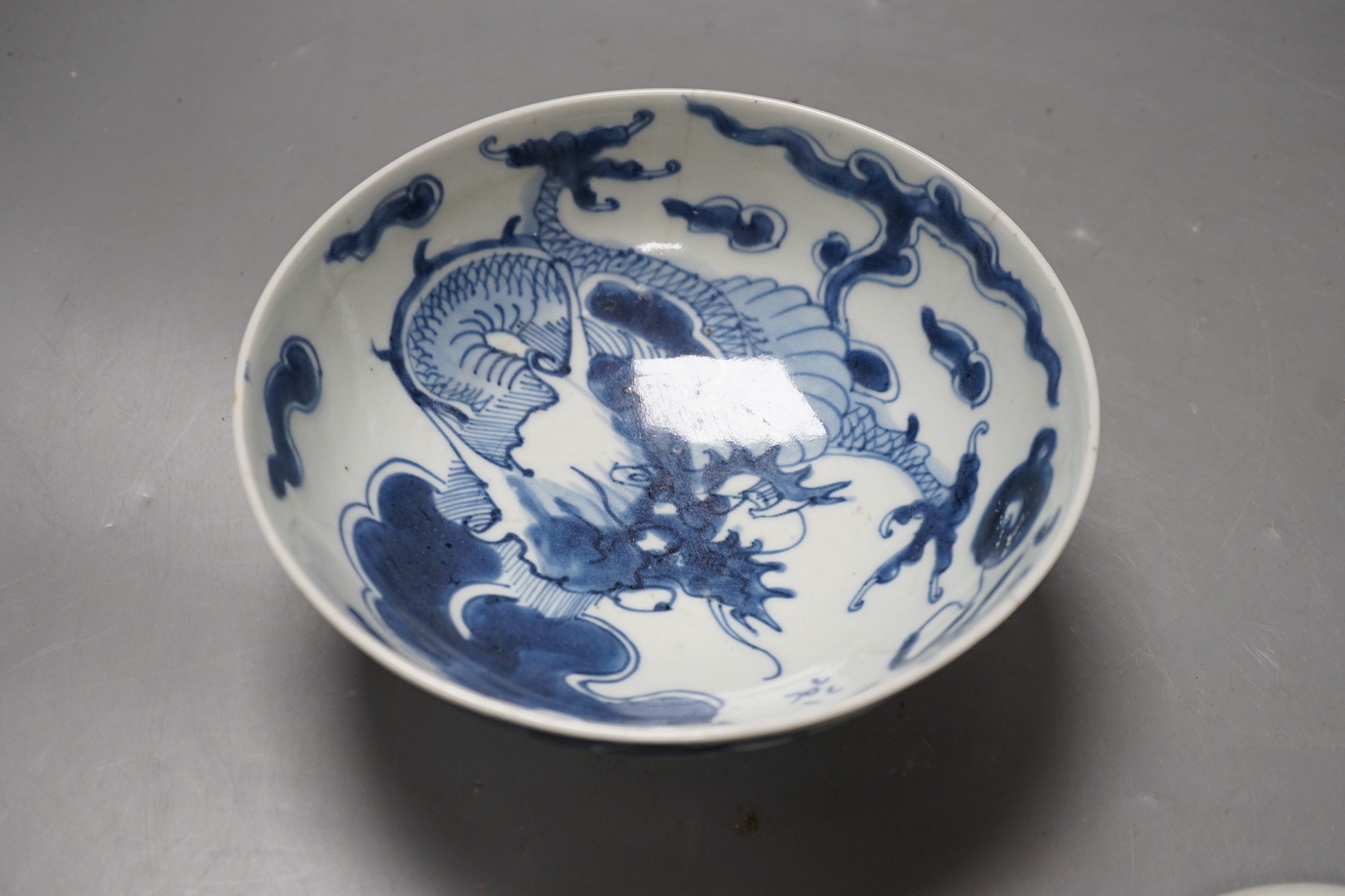 A 19th century Chinese ‘dragon’ bowl, together with a smaller ‘dragon’ dish. Largest 18.5cm diameter